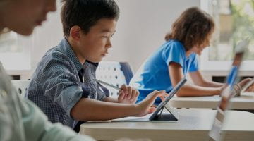 A boy using a tablet at school